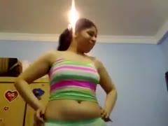 Non-professional plump A brunette from Pakistan dances on a webcam while wearing bright clothing.
